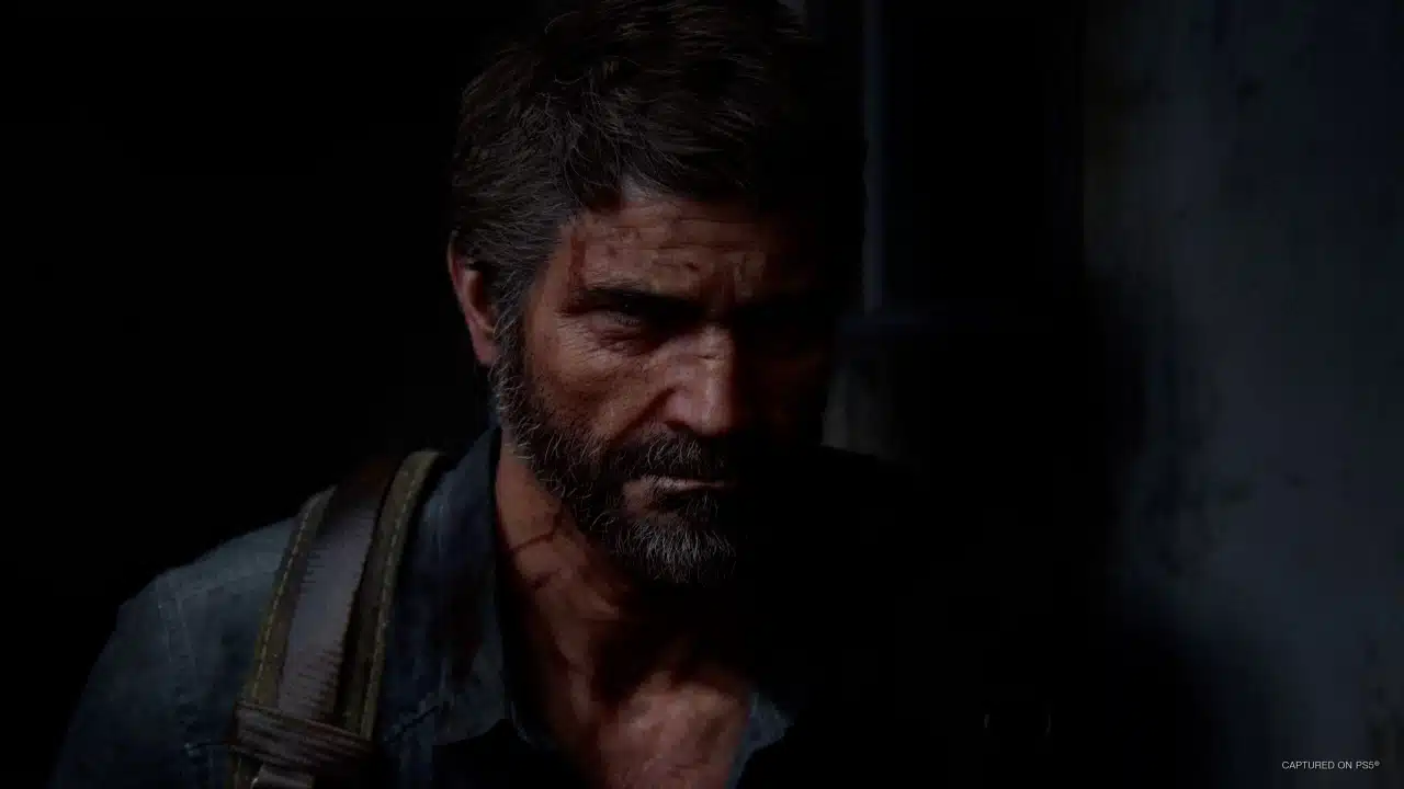 imagem de The Last of Us Part II Remastered com um homem de barba na escuridão com um olhar enfurecido